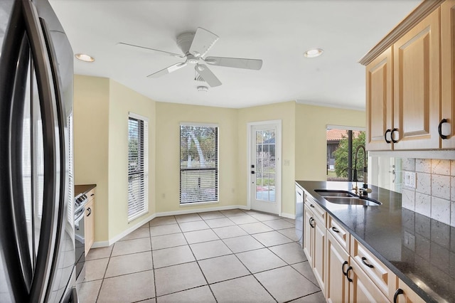 kitchen with ceiling fan, fridge, tasteful backsplash, light brown cabinetry, and light tile patterned floors