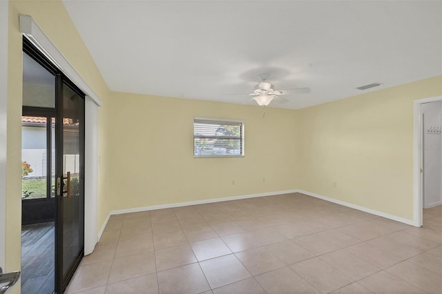 spare room with light tile patterned floors, baseboards, visible vents, and a ceiling fan