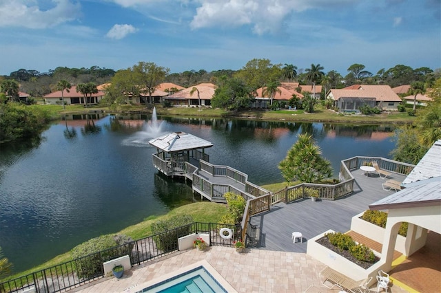 exterior space featuring a pool side deck with water view