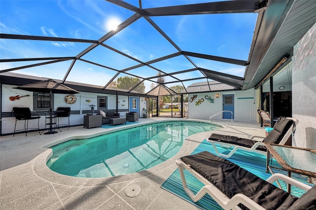 pool featuring glass enclosure, a patio, and an outdoor hangout area