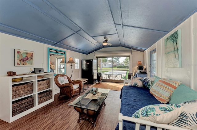 living area with wood finished floors and vaulted ceiling