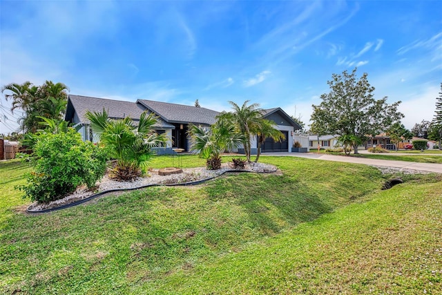 view of front of home with a front yard, an attached garage, and driveway