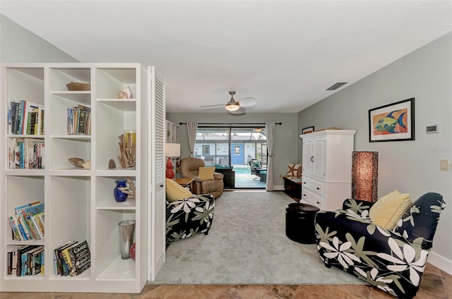 living area with visible vents, carpet flooring, baseboards, and ceiling fan