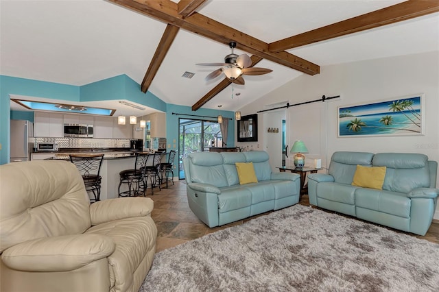 living room featuring a barn door, ceiling fan, and vaulted ceiling with beams