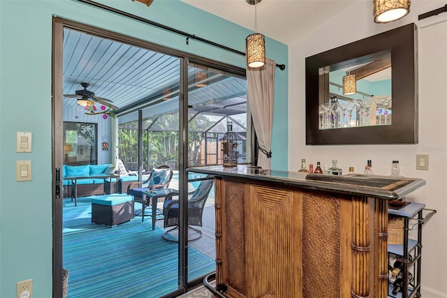 bar with ceiling fan, carpet floors, and vaulted ceiling