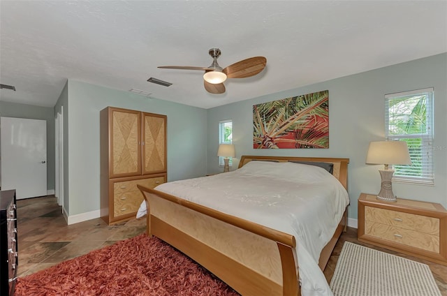 bedroom with a ceiling fan, baseboards, and visible vents