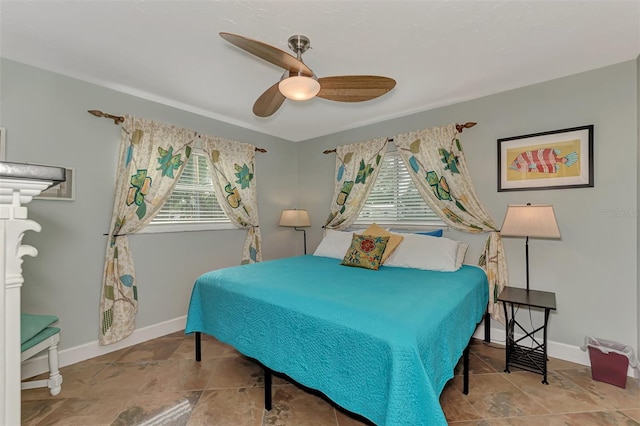 bedroom with baseboards and a ceiling fan