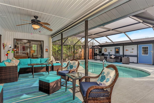 outdoor pool featuring a patio area, an outdoor living space, glass enclosure, and a ceiling fan