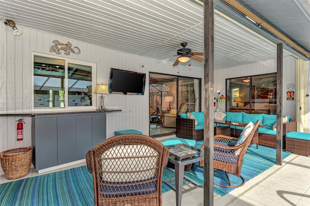 view of patio with an outdoor living space and ceiling fan