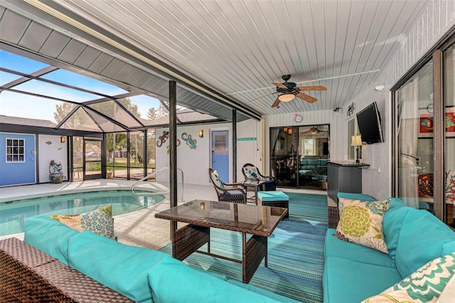 pool featuring an outdoor living space, a ceiling fan, a lanai, and a patio