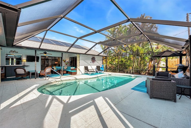 view of pool with a patio area and a lanai