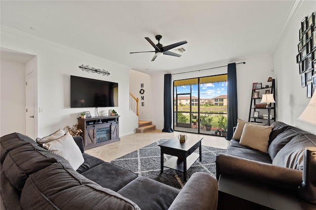 living room with light tile floors, ceiling fan, and ornamental molding