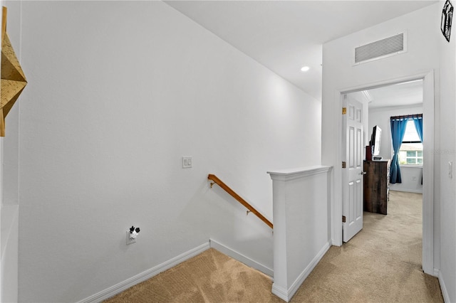 hallway featuring light carpet