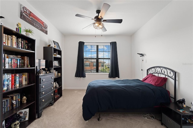 bedroom with ceiling fan and light colored carpet