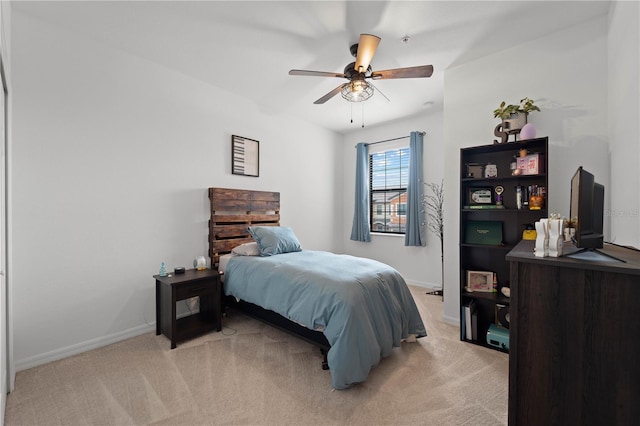 bedroom featuring light carpet and ceiling fan