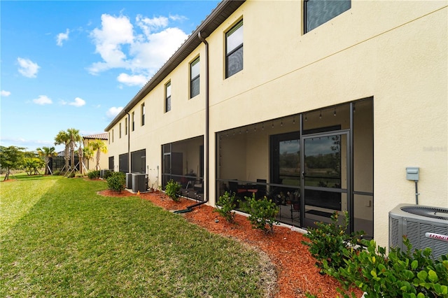 view of home's exterior featuring a yard and central air condition unit