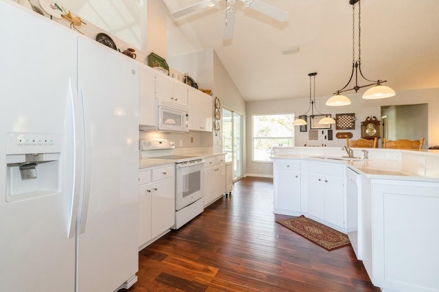 kitchen with hanging light fixtures, dark wood-type flooring, white appliances, vaulted ceiling, and white cabinetry