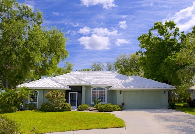 ranch-style house featuring a front yard and a garage