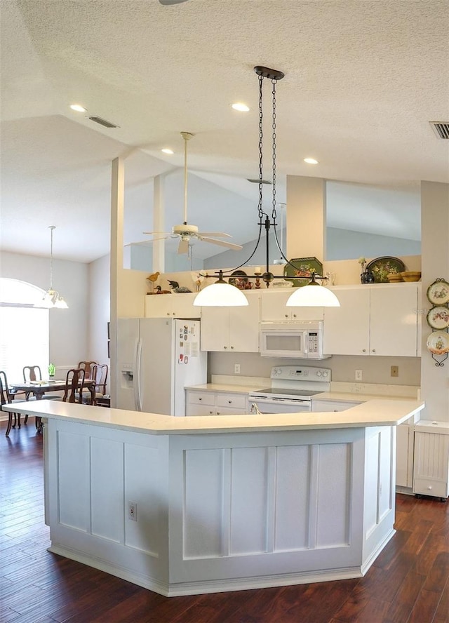 kitchen with white cabinets, white appliances, and dark wood-type flooring