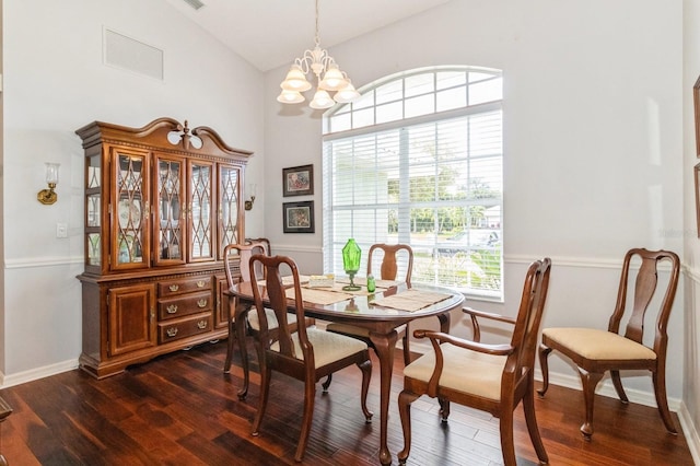 dining room featuring an inviting chandelier, dark hardwood / wood-style flooring, and lofted ceiling