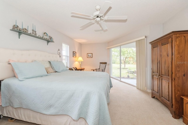 bedroom featuring light carpet, ceiling fan, and access to outside