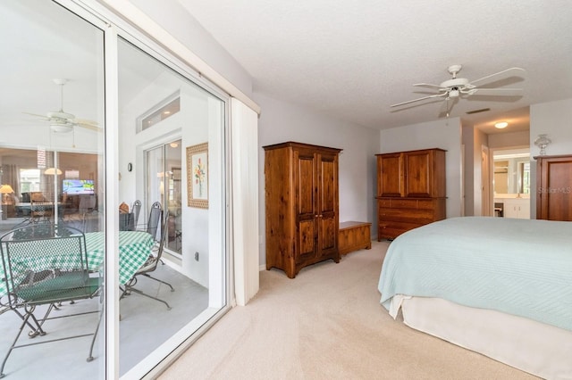 carpeted bedroom with a textured ceiling, access to exterior, and ceiling fan