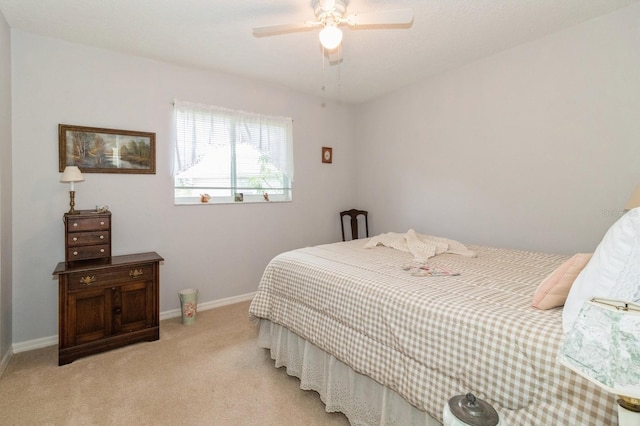 bedroom with ceiling fan and light carpet