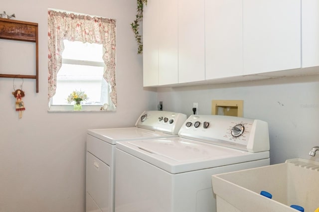 laundry room featuring electric dryer hookup, cabinets, separate washer and dryer, and sink