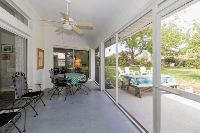 sunroom featuring plenty of natural light, vaulted ceiling, and ceiling fan