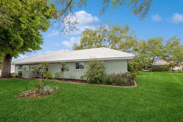 view of property exterior with a yard