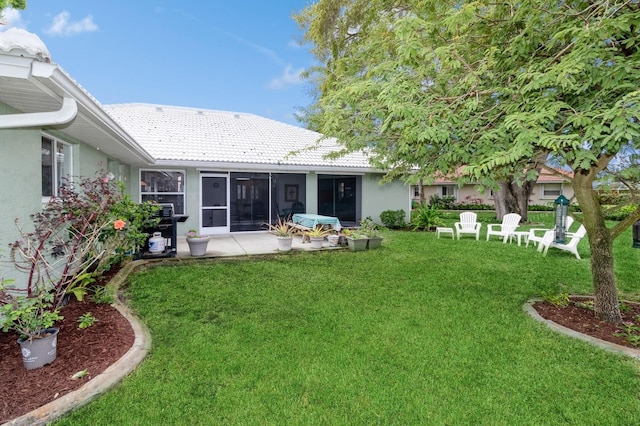 rear view of property featuring a yard