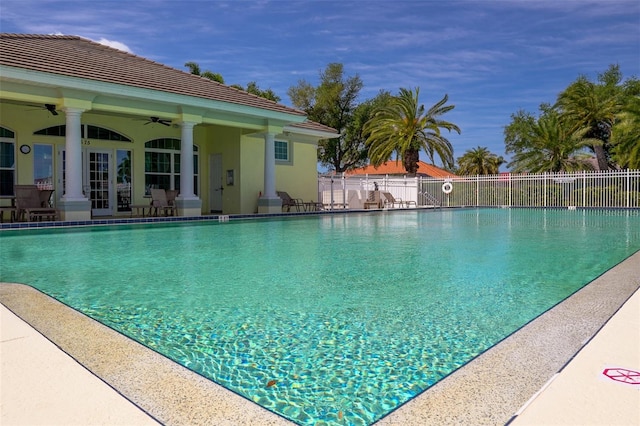 view of swimming pool featuring french doors, a patio area, and ceiling fan