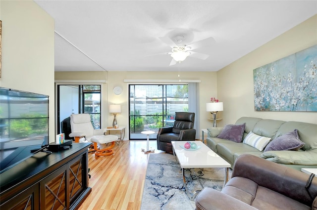 living room featuring ceiling fan and light wood-type flooring