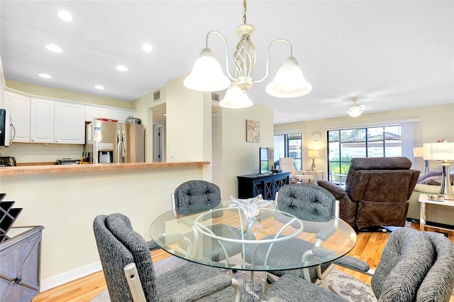 dining room featuring an inviting chandelier and light wood-type flooring