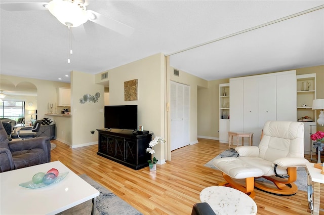 living room featuring ceiling fan and light hardwood / wood-style flooring