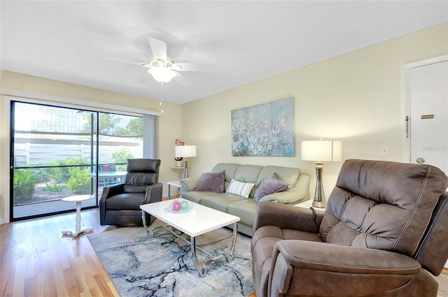 living room featuring light hardwood / wood-style floors and ceiling fan