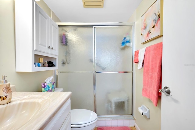 bathroom with vanity, tile flooring, a shower with shower door, and toilet