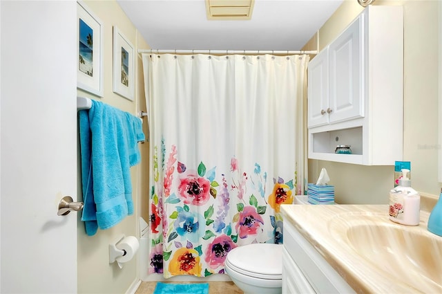 bathroom featuring toilet and vanity with extensive cabinet space