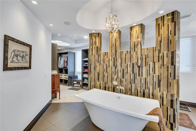 bathroom with tile patterned flooring, a bathtub, and tile walls