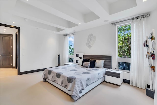 bedroom with beamed ceiling, light colored carpet, and multiple windows