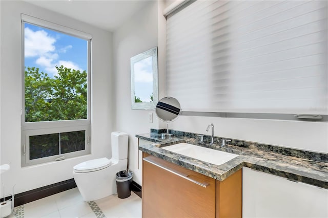 bathroom with vanity, toilet, and tile patterned flooring