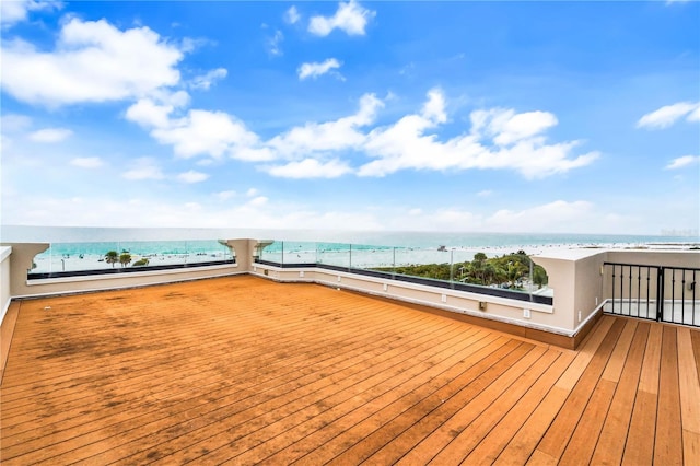 wooden terrace with a water view and a beach view