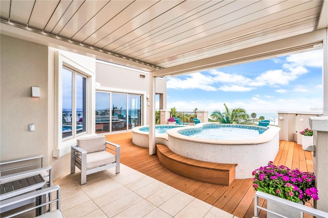 view of patio / terrace featuring a swimming pool with hot tub