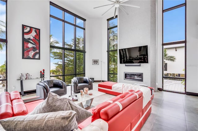 living room featuring a towering ceiling and a wall of windows