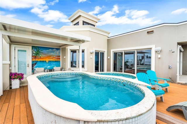 view of swimming pool with a hot tub and a wooden deck