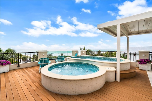 view of swimming pool featuring an outdoor hot tub