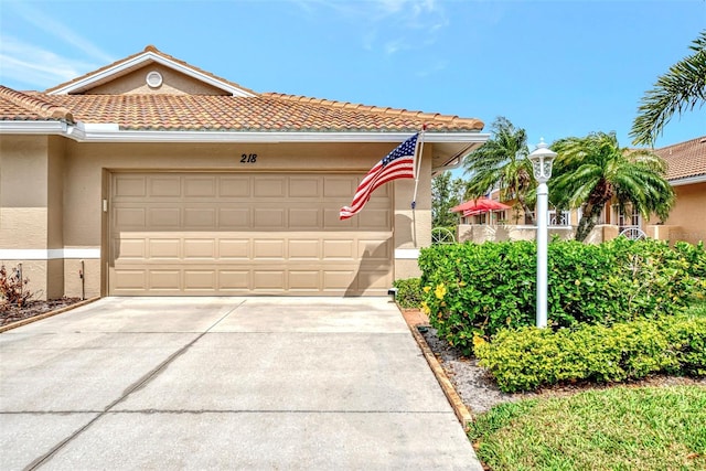 mediterranean / spanish-style home with a garage