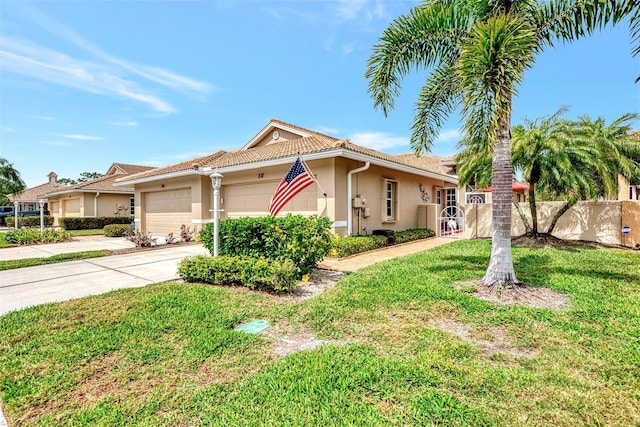 view of front of property with a front yard and a garage