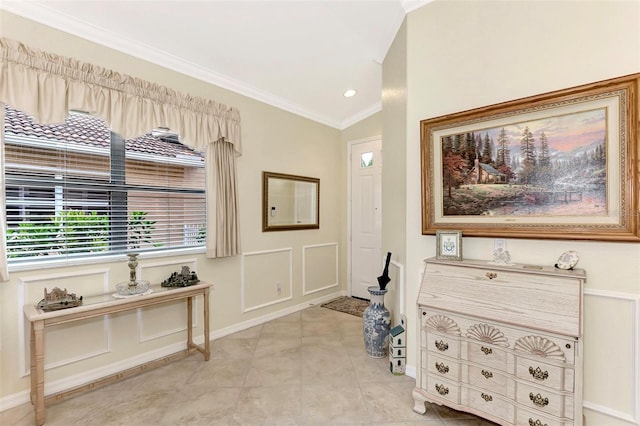 living area featuring light tile floors, vaulted ceiling, and ornamental molding