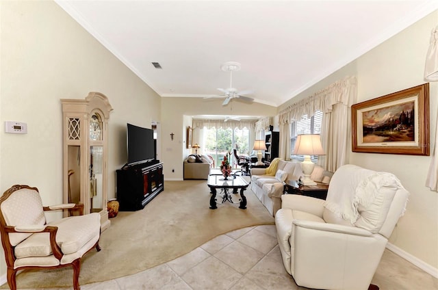 tiled living room with ornamental molding and ceiling fan